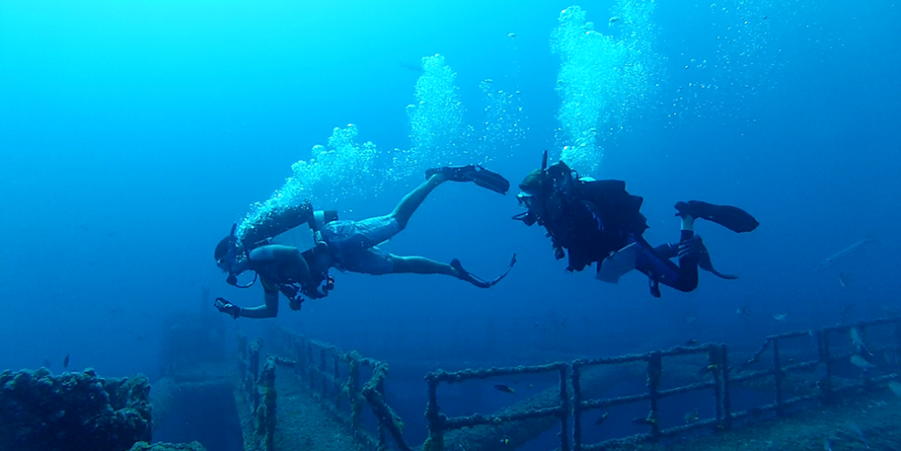 Two divers about to begin a fish survey on reef site MI-A-7, a cutoff platform.